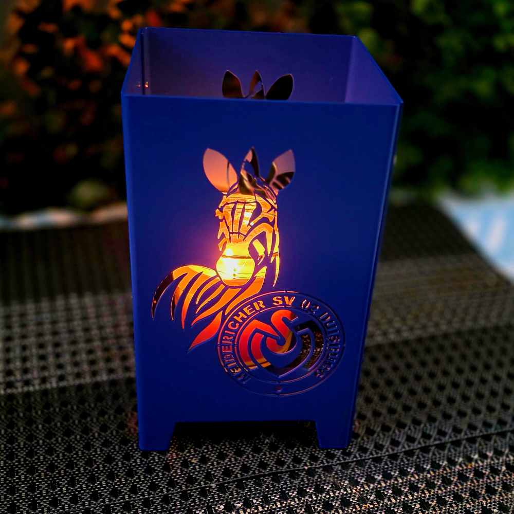Windlicht MSV Duisburg in der Vereinsfarbe Blau pulverbeschichtet. Stimmungsvolles Windlicht mit Kerzenschein. Abmessung 120 mal 120 mm und 200 mm hoch. Handgefertigt im traditionsreichen Handwerksbetrieb Viefhaus in Oberhausen.