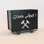 Lore in schwarz matt pulverbeschichtet als Dekoration mit dem Schriftzug Glück auf