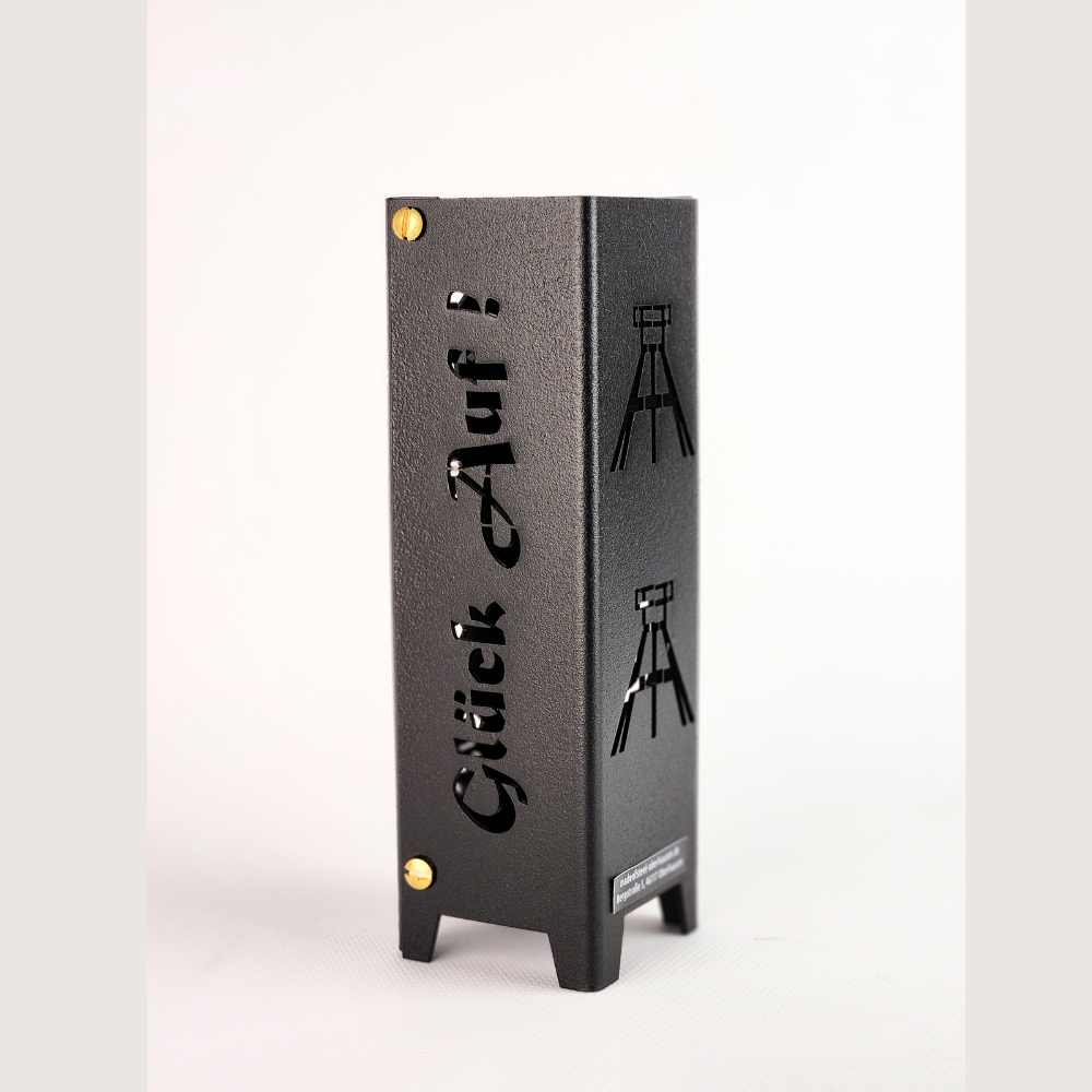 Teelicht Essen aus Metall und in schwarz matt feinstruktur pulverbeschichtet.Schriftzug Glück auf auf einer Seite und auf der zweiten Seite Symbole Fördertürme.