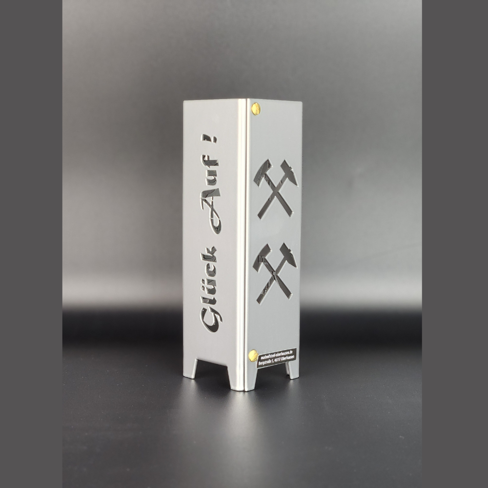 Teelicht aus Metall mit dem Schriftzug Glück auf und Eisen Schlägel Symbol